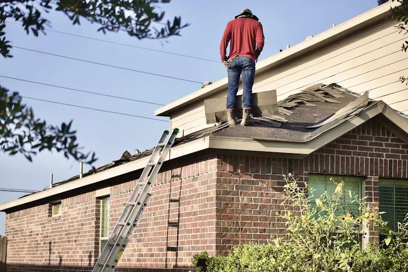 Professional roofer working on a residential roof in Falconhurst